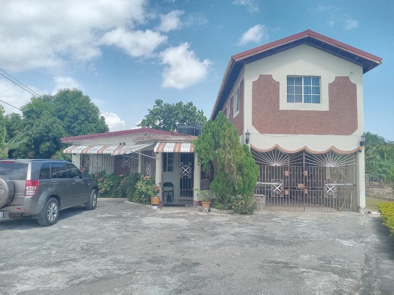 Investment-Opportunity-Two-Family-House-for-Sale-on-1.5-Acres-in-Vineyards-Estate-St.-Catherine-Jamaica First image of Vineyards Estate in Old Harbour, St. Catherine, Jamaica - property is For Sale