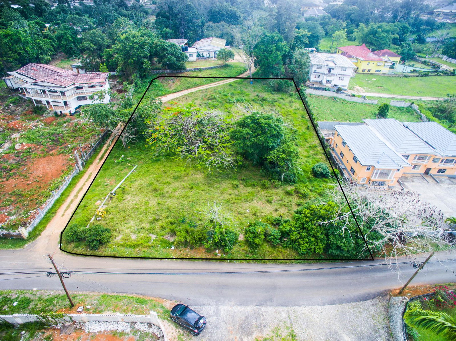 Prime-Residential-Development-Lot-for-Sale-in-Mandeville-Manchester-Jamaica First image of 1 Battersea Clarkes Town rd in Mandeville, Manchester, Jamaica - property is For Sale